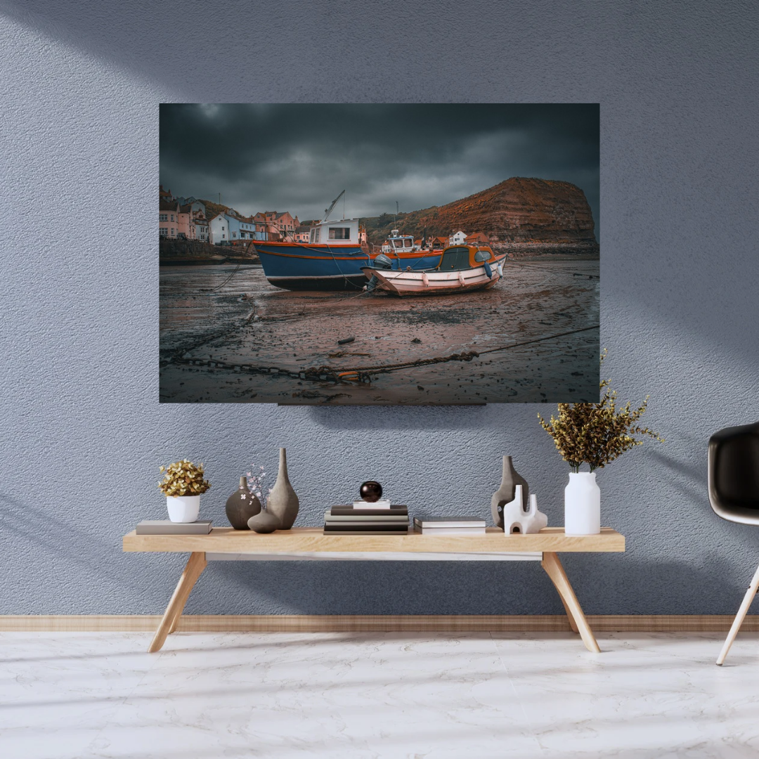 Moody skies over Staithes Harbour low tide Print.