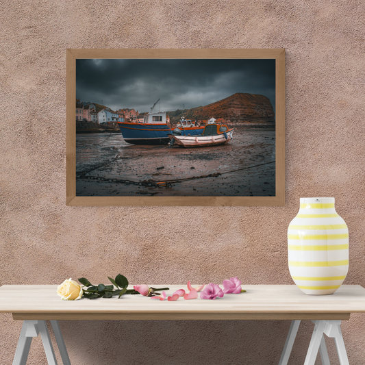 Moody skies over Staithes Harbour low tide Print.