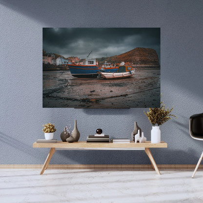 Moody skies over Staithes Harbour low tide Print.