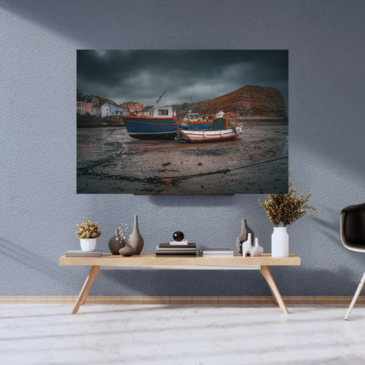 Moody skies over Staithes Harbour low tide Print.
